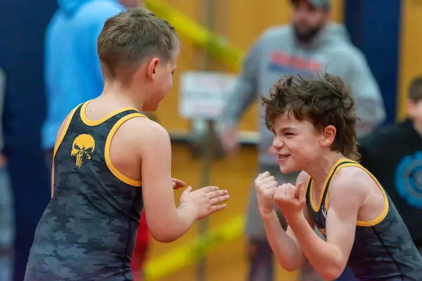 Two young Rangers wrestlers face off with big grins