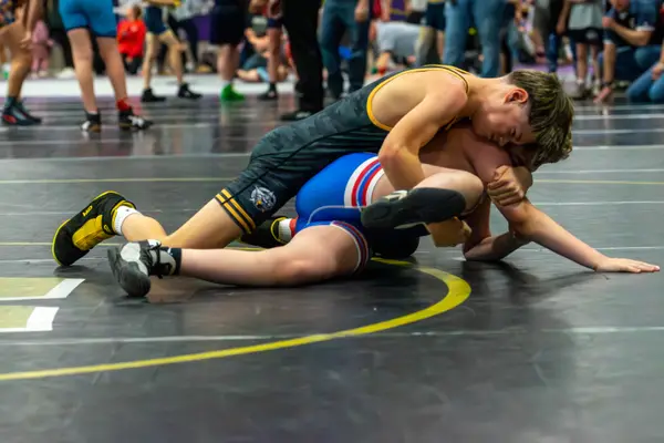 A Rangers wrestler rides an opponent in a red, white and blue singlet