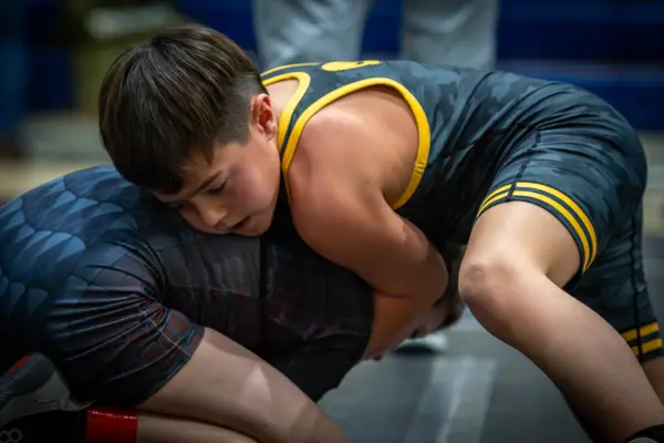 Close-up of a Rangers wrestler wrapping up an opponent